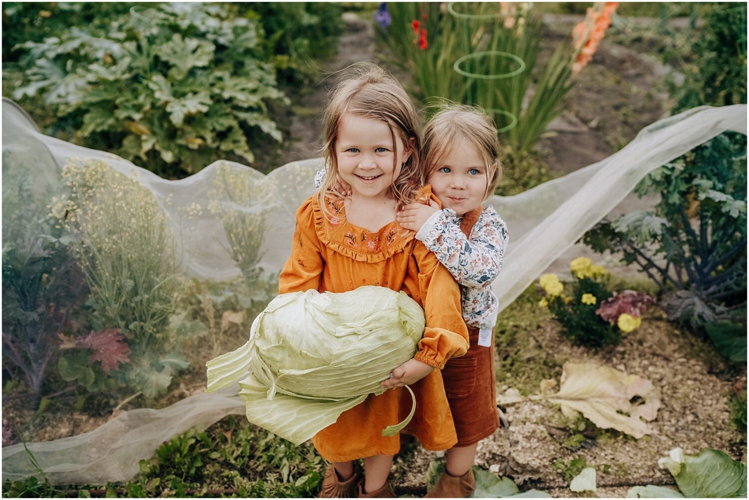 Edmotnon family photographer kids holding a cabbage
