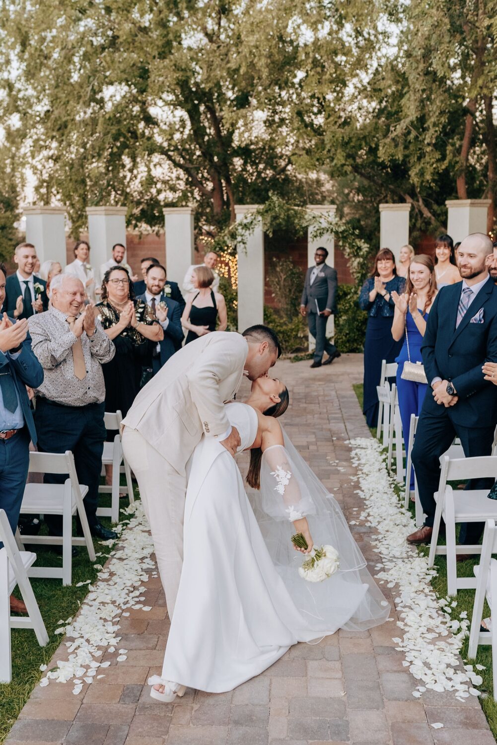 Bride and groom first kiss at Stonebridge Manor in Phoenix Arizona wedding photographer
