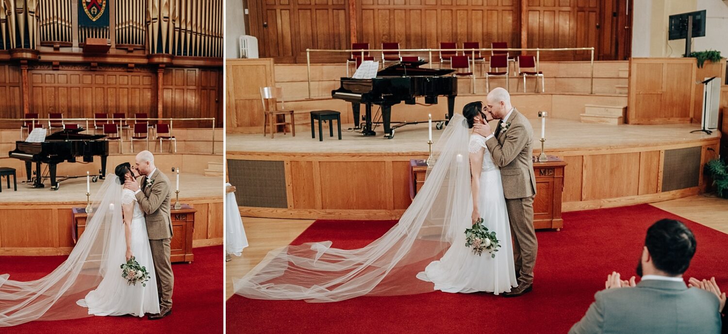 Edmonton wedding photographer bride and groom first kiss at McDougall Church