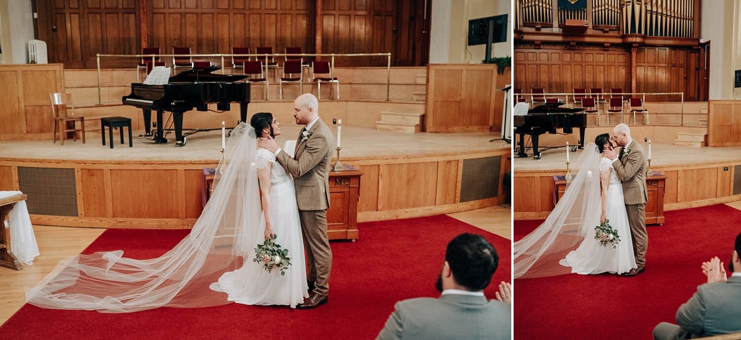 Edmonton wedding photographer bride and groom first kiss at McDougall Church